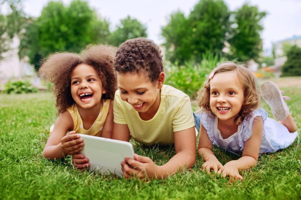 Happy,Little,Kids,Holding,Tablet,Pc,Outdoors,In,Summer,Park
